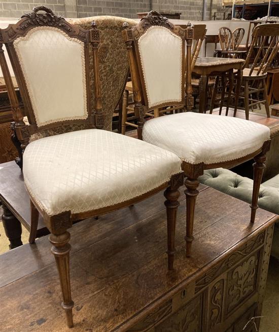 A pair of Victorian carved walnut salon chairs
